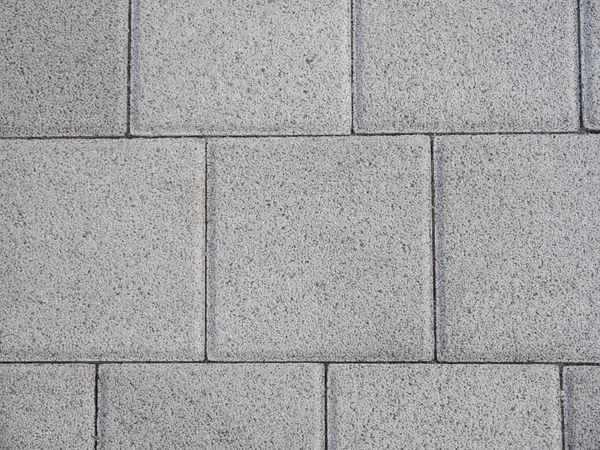 Beton tiles on the sidewalk as a texture