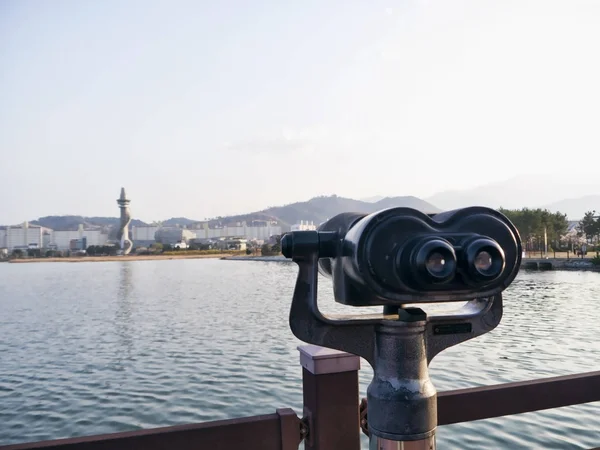 Observation binoculars on the pier and Sokcho city on the background, South Korea