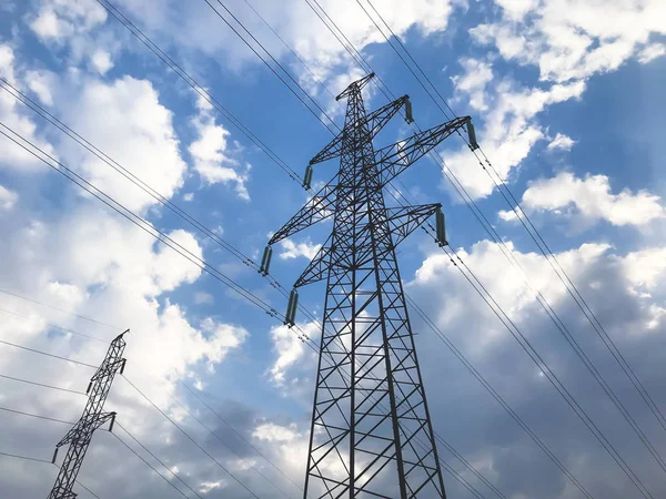 The power line. High voltage pole and blue sky on the background