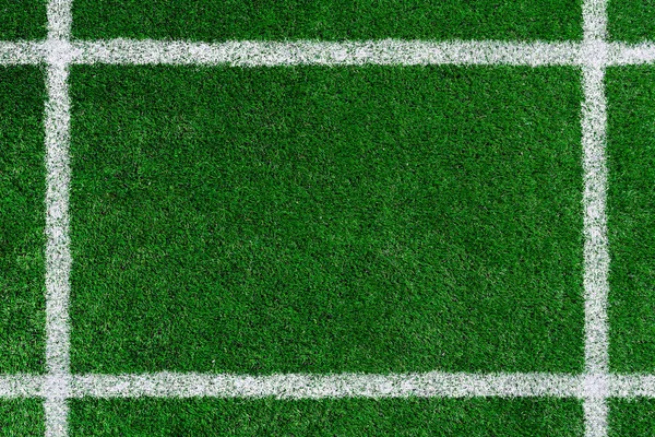 the frame is drawn on a green football field with white paint