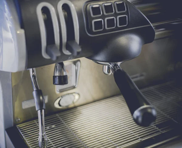 Close-Up of coffee machine in the coffee shop. len blur effect Soft focus and focus to Steam Milk stick. Process with vintage style