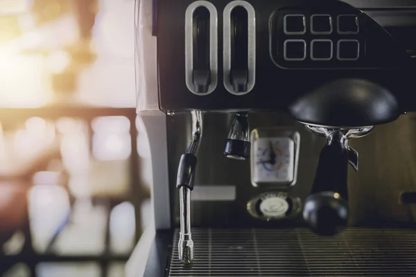 Close-Up of coffee machine in the coffee shop. len blur effect. Process with vintage style