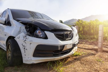 Beyaz renkli araba ön hasarlı ve yolda kaza parkı tarafından kırık artık sürücü olamaz.