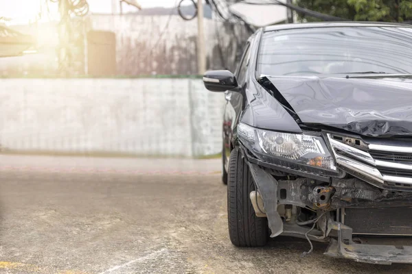 Front of black car big damaged and broken by accident on road parking can not drive any more. With copy space for text or design — Stock Photo, Image