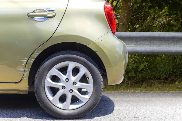 Choque de coche. Al lado del coche de color verde profundo tienen arañazos de daños en la carretera. Primer plano rasguño — Foto de Stock