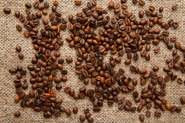 キャンバスとコーヒー豆の垂直写真の背景 — ストック写真