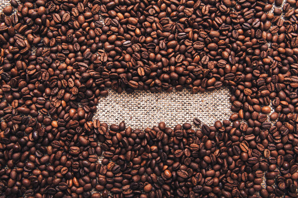 Coffee beans and sackcloth background. Copy Space