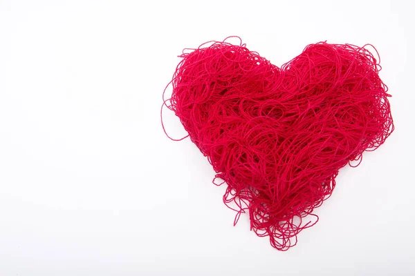 stock image big heart of red threads on white background