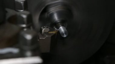 Torna iş başında. Geç gösteride eski deri. Makinenin operatörü eski bir deri üzerinde çalışır. Parça üretimi.