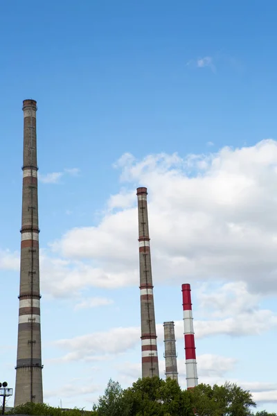 factory chimneys on background of blue sky