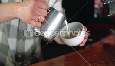 Barista üzerinde sıcak kahve cafe latte sanat resim yaprak ve kalp yapmak.