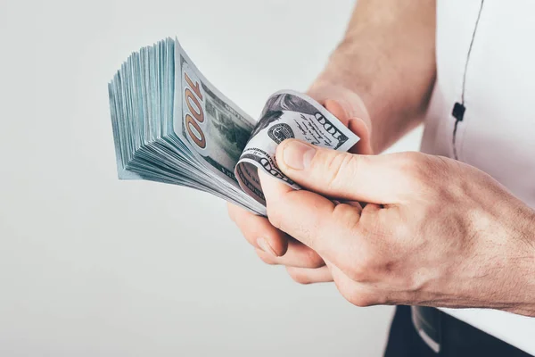 a businessman holds money in his hands and  counts his income. Money is stacked in dollar bills