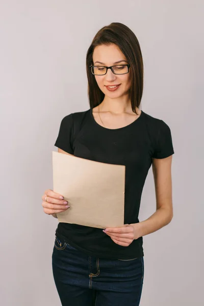 Pretty Girl Glasses Holds Document Her Hands Reads — Stock Photo, Image
