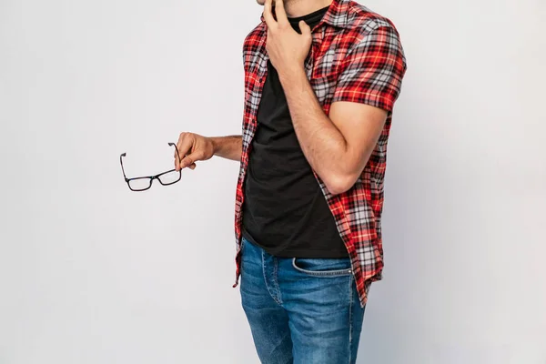 Man Red Plaid Shirt Jeans Holds Temple Eyeglasses His Hand — Stock Photo, Image