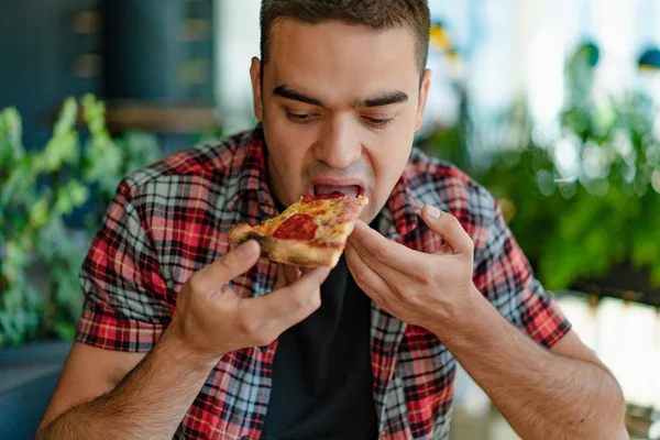 Man Sits Eats Juicy Slice Pizza Cheese Meat Sauce Cafe — Stock Photo, Image