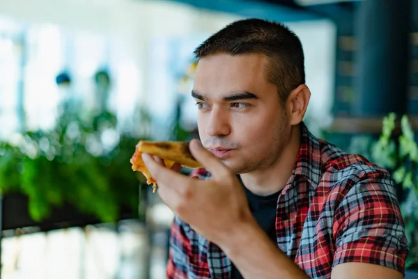 Hombre Con Una Camisa Cuadros Sostiene Una Rebanada Pizza Mano —  Fotos de Stock