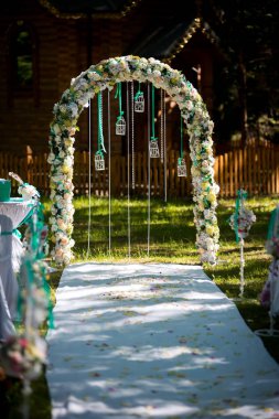 Arch düğün töreni için. Çiçek ve yeşillik ile dekore edilmiştir. Bir çam ormanında yer almaktadır. Yeni evli. Dekor düğün.