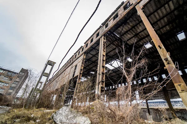 Verlassene Fabrik nach der Wirtschaftskrise mit zerstörten Mauern draußen. alte Fabrikruinen, Außenfassade, Industriegebäude — Stockfoto