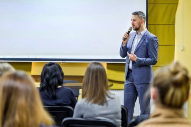 Kürsüde hoparlör. Konferans salonundaki insanlar..