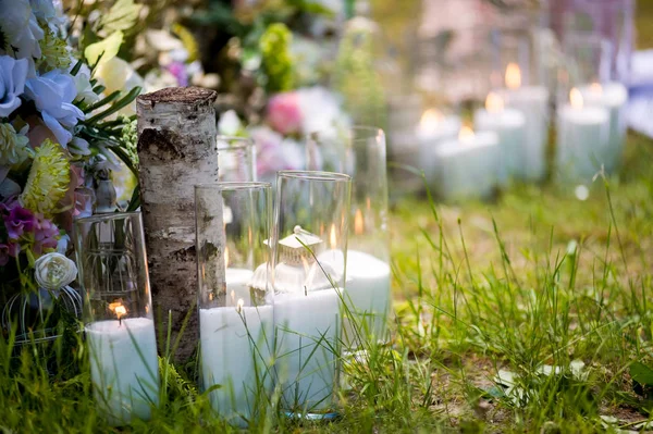 Wedding decor. Solemn ceremony. Wedding in nature. Candles in decorated jars. Just married.