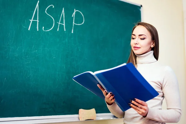 Attractive teacher or student at the blackboard — Stock Photo, Image