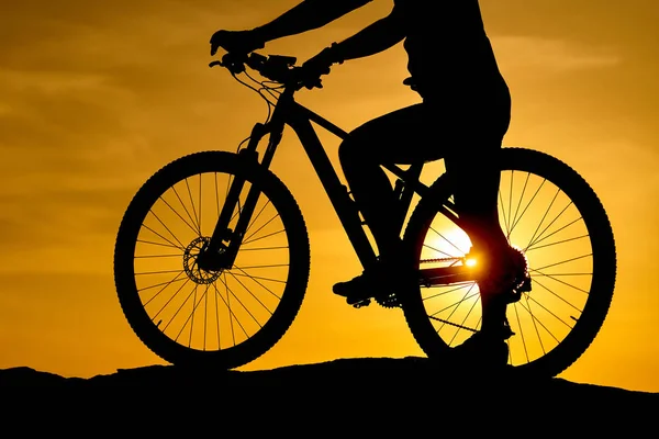 Silhouette Young man of cycling on sunset background. Bicycle and ecology lifestyle concept.