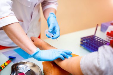 Close up of nurse's hand running blood sample analysis for diagnosis and treatment of a patient. Blood chemistry diagnosis by automatic machine. Closeup.