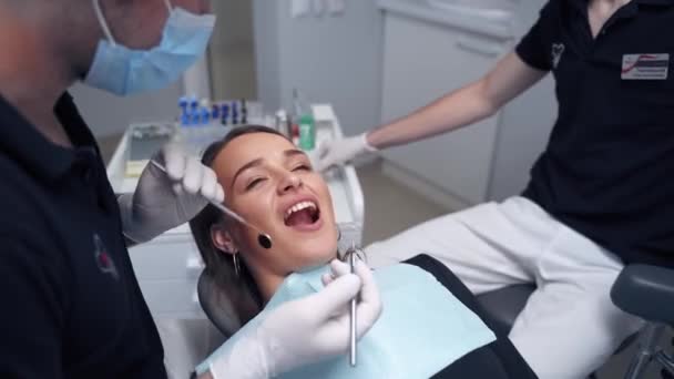 Dentist Examines Woman Teeth Female Face Opened Mouth Dental Chair — Stock Video