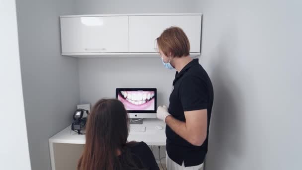 Stomatologist Giving Consultation Woman Doctor Shows Young Patient Situation Her — Stock Video