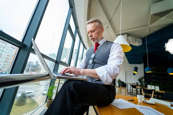 Przemyślany Biznesmen Średnim Wieku Garniturze Siedzi Laptopem Przy Oknie Człowiek — Zdjęcie stockowe