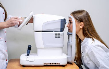 The universal tool of the optometrists and oculists. Checking eyesight. Eyesight correction. Closeup. Patient in clinic clipart