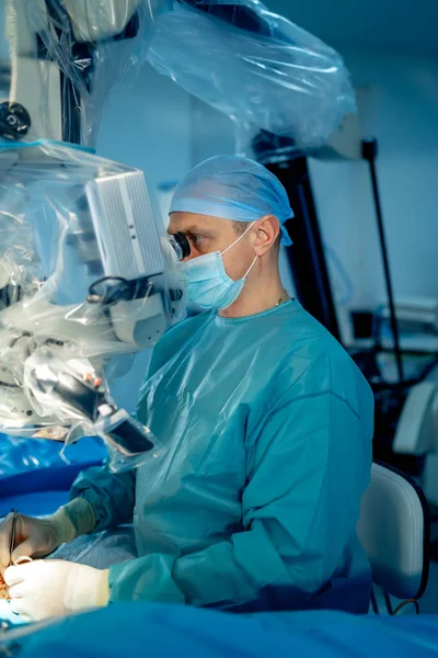 Doctor performs minimally-invasive surgeon using a robotic device. Minimal invasive surgical innovation, medical robot surgery with endoscopy.