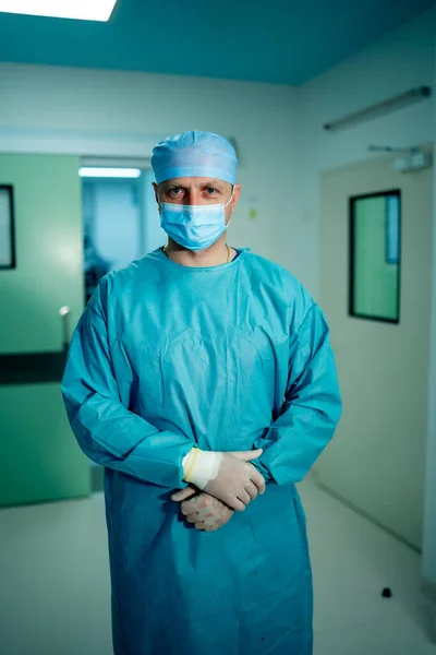 Портрет хірурга в скрабах, що стоять в операційному театрі. Портрет лікаря-чоловіка в сучасній медичній кімнаті . — стокове фото