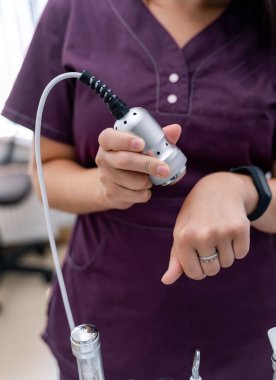 Dermatoloji kliniğinde ekipmanlı bir oda. Kozmetik uzmanı kadın seçmelere katılıyor. Özel ekipman başlığıyla seçici odaklanma.