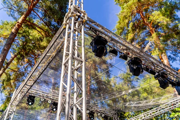 Part of metal structures with lights at height. Concert outdoor. Closeup.
