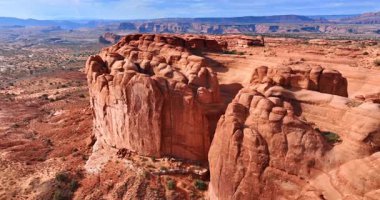 Parlak güneşle parıldayan güzel kırmızı sarp kanyonlara yaklaşıyoruz. Utah, ABD 'deki Arches Ulusal Parkı' nın büyük çölündeki hava manzarası..
