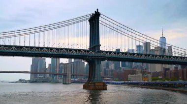 New York, ABD, 1 Ağustos 2025: New York 'taki East River üzerindeki Manhattan Köprüsü. Manhattan Köprüsü, New York şehrinin silueti ile Doğu Nehri üzerinden yükseliyor..