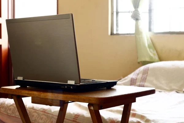 Laptop computer on a wooden table — Stock Photo, Image