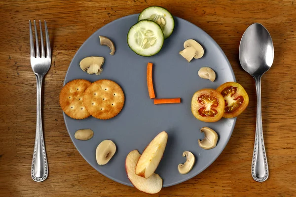 Different healthy foods arranged like a clock on a plate. — Stock Photo, Image