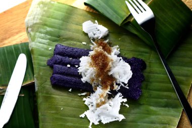 Yeni pişirilmiş Filipin lezzetinin fotoğrafı. Adı puto bumbong veya bambu tüplerinde pişirilmiş mor glutenöz pirinç.