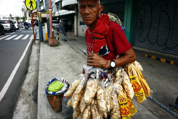 Filipino delicacy called Chicharon or fried crispy pork skin with fat being sold by a street vendor. — Stock Photo, Image