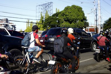 Cainta, Rizal, Philippines - July 7, 2020: Motorcycle riders along a busy and congested road during rush hour in the morning.