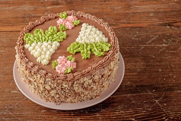 Homemade Kiev cake on old wooden table. The known ukrainian delicacy. Copy space for text, close-up view.