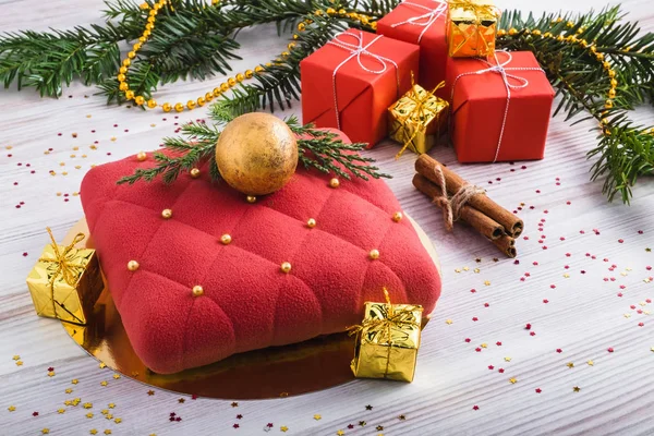 red mousse cake and festive gift boxes