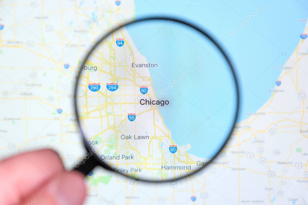 city of Chicago, Illinois on the display screen through a magnifying glass
