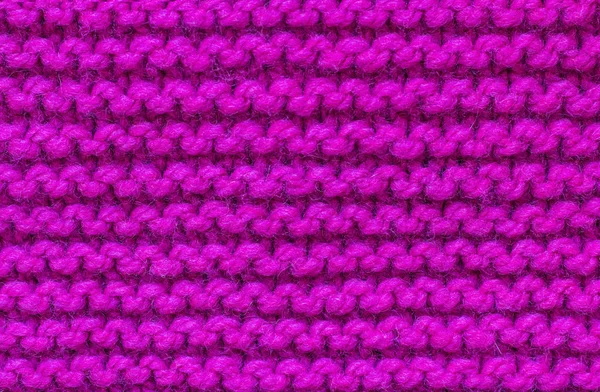 knitted pattern front and back loops of pink wool