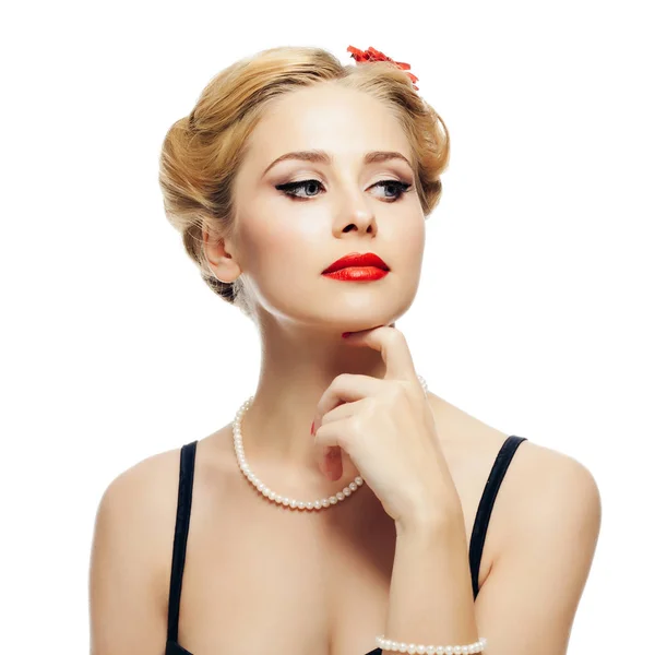 Blonde girl style pin-up in black dress and pearl necklace looks to side and touches chin with your hand. isolated on white background — Stock Photo, Image