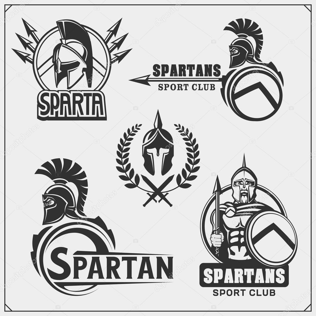 Set of spartans emblems and labels. Sport club design elements and templates. Ancient warriors, spartan spirit, gladiator helmets.