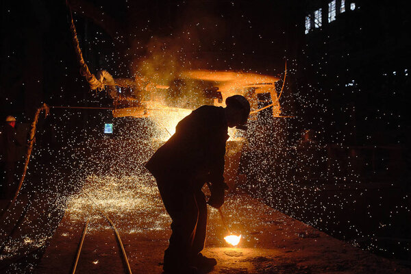 Steelmaker at ingot casting. Electric arc furnace shop EAF. Metallurgy.