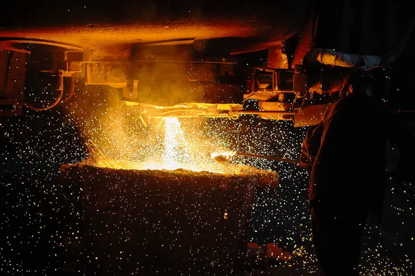 Steelmaker at ingot casting. Electric arc furnace shop EAF. Metallurgy.